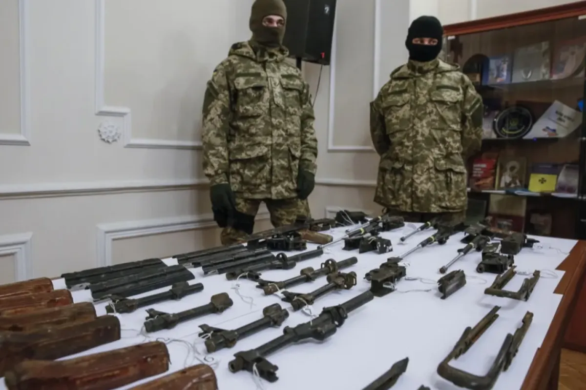 Membrii Serviciului de Securitate al Ucrainei (SBU) stau lângă o masă cu părți de arme în timpul unei conferințe de presă la Kiev, Ucraina, 6 februarie 2016.