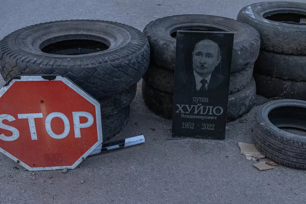 A plate depicting a portrait of Russian President Vladimir Putin, with a mustache added on it to show him as Adolf Hitler, is placed at a checkpoint on a road between Zaporizhzhia and Dnipro cities, Ukraine, 26 March 2022.